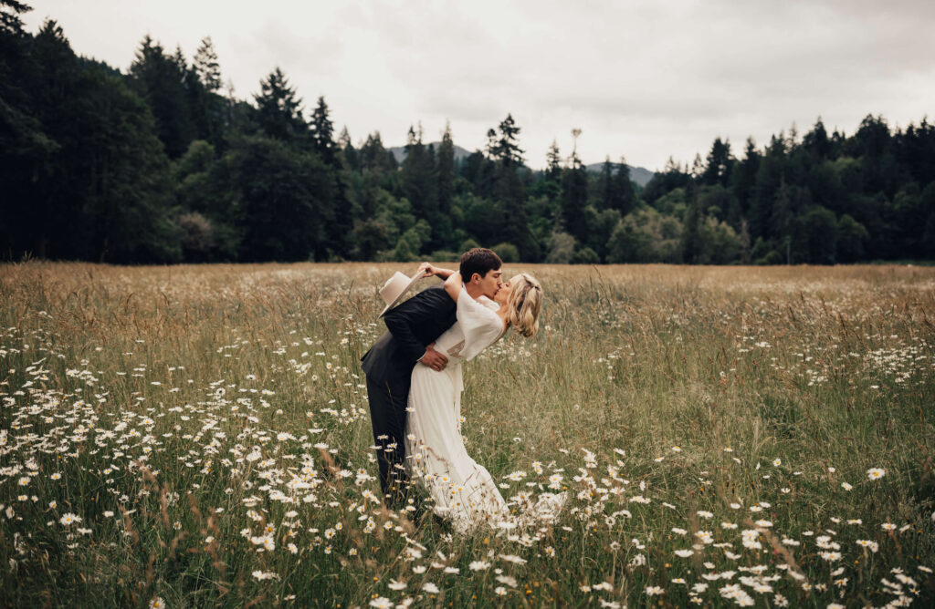 Oregon bride and groom kiss in a field at weddings for mom in alsea at sunset