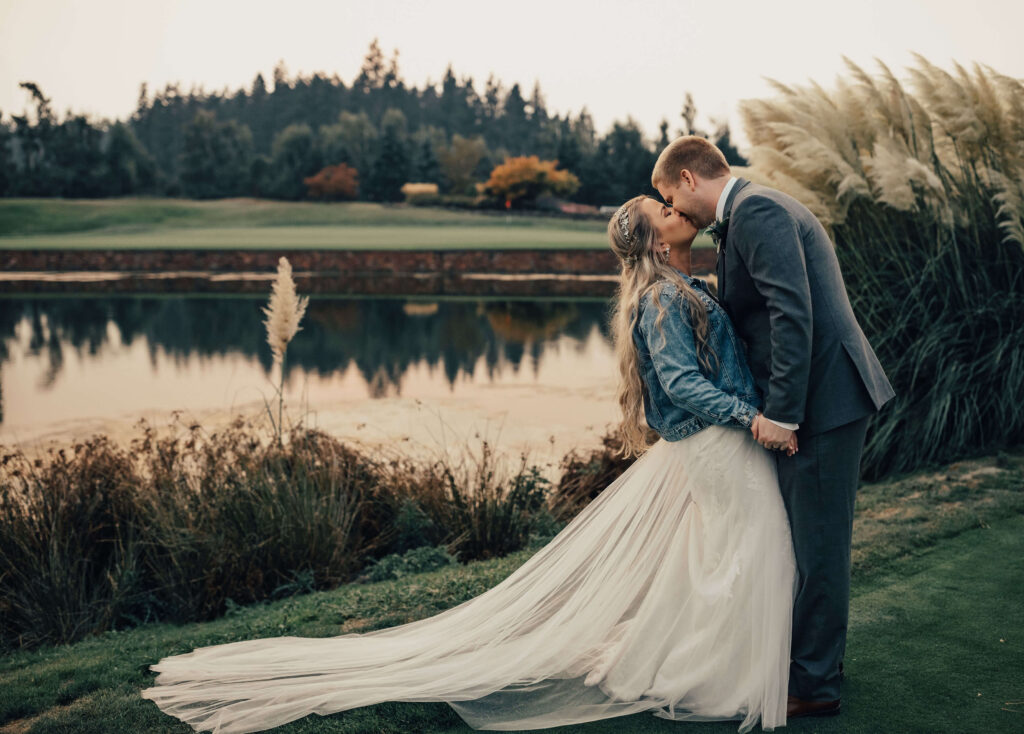 Couple kisses next to a lake at Langdon Farms in canby