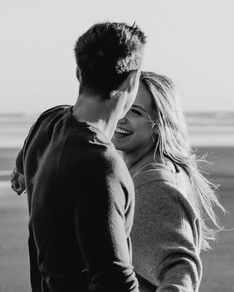 Couple holding hands on the beach at the Oregon Coast