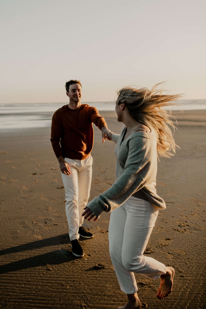 Couple holding hands on the beach at the Oregon Coast