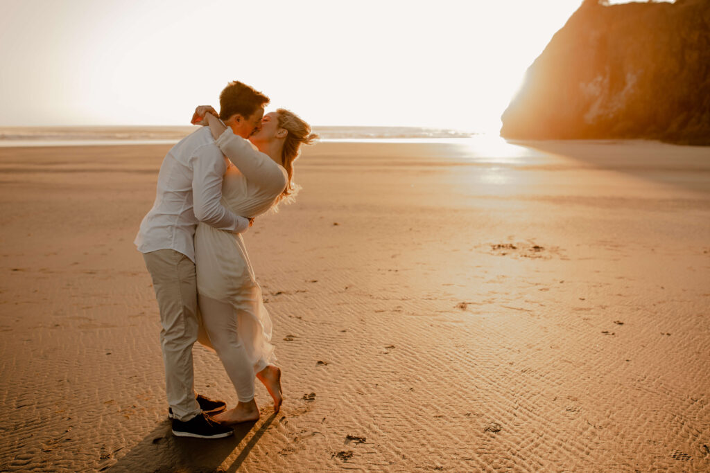 Couple dances on the beach for an oregon coast engagement session