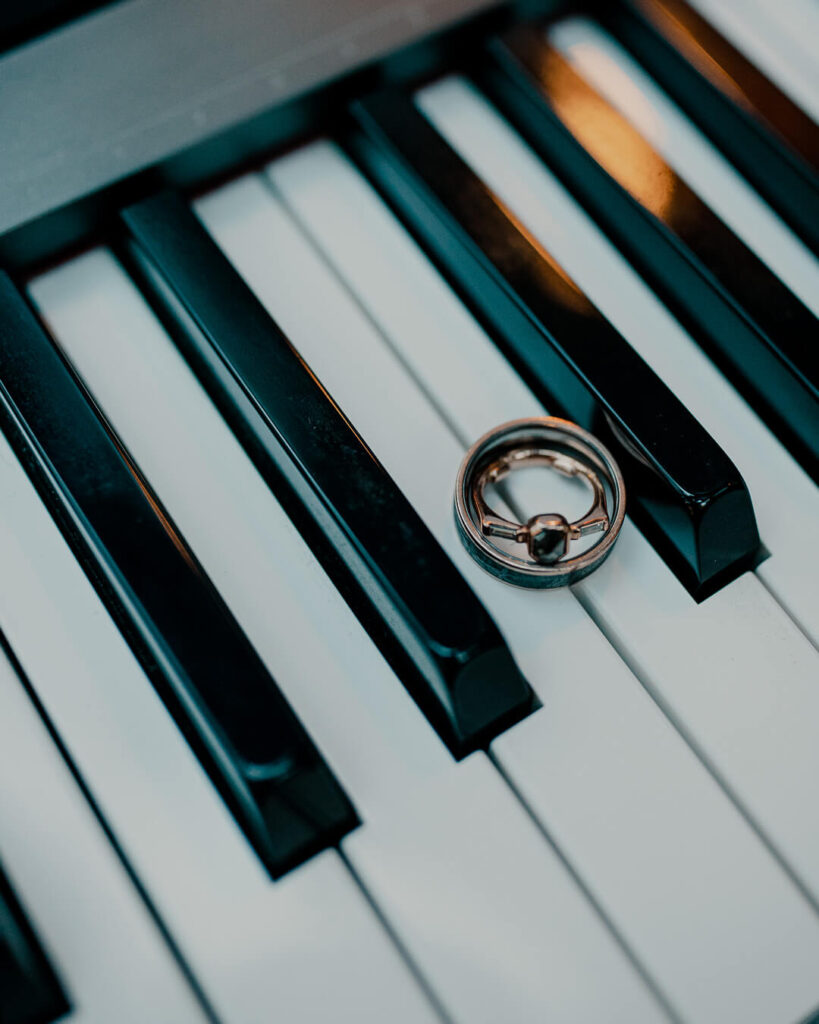 custom wedding rings on piano keys