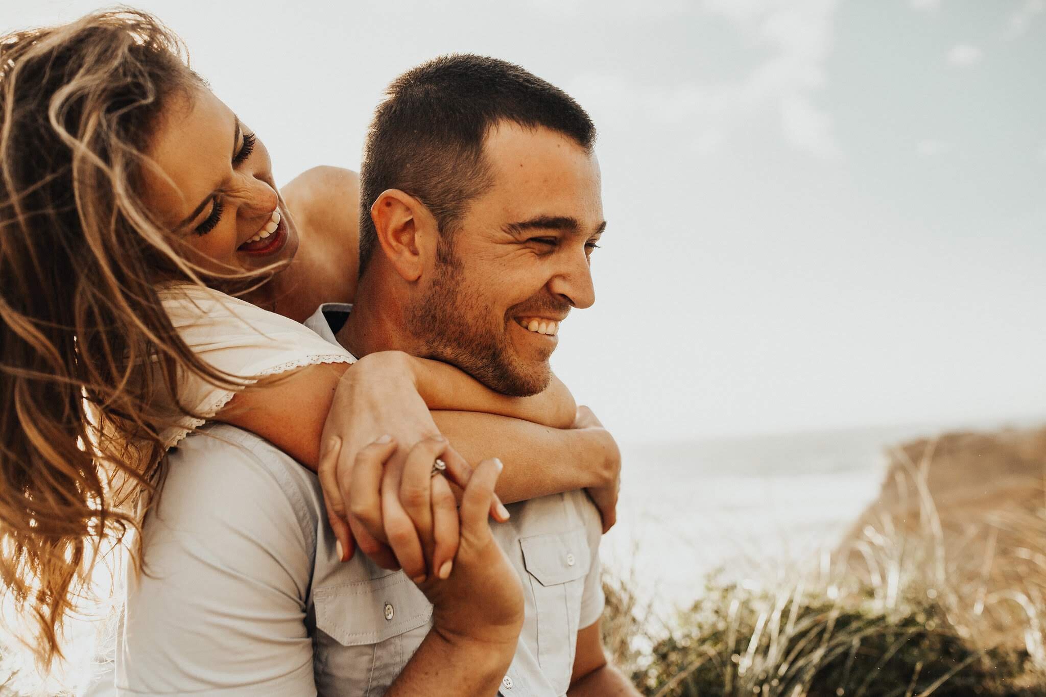 Dani of Ronny and Rene photography poses with her husband.