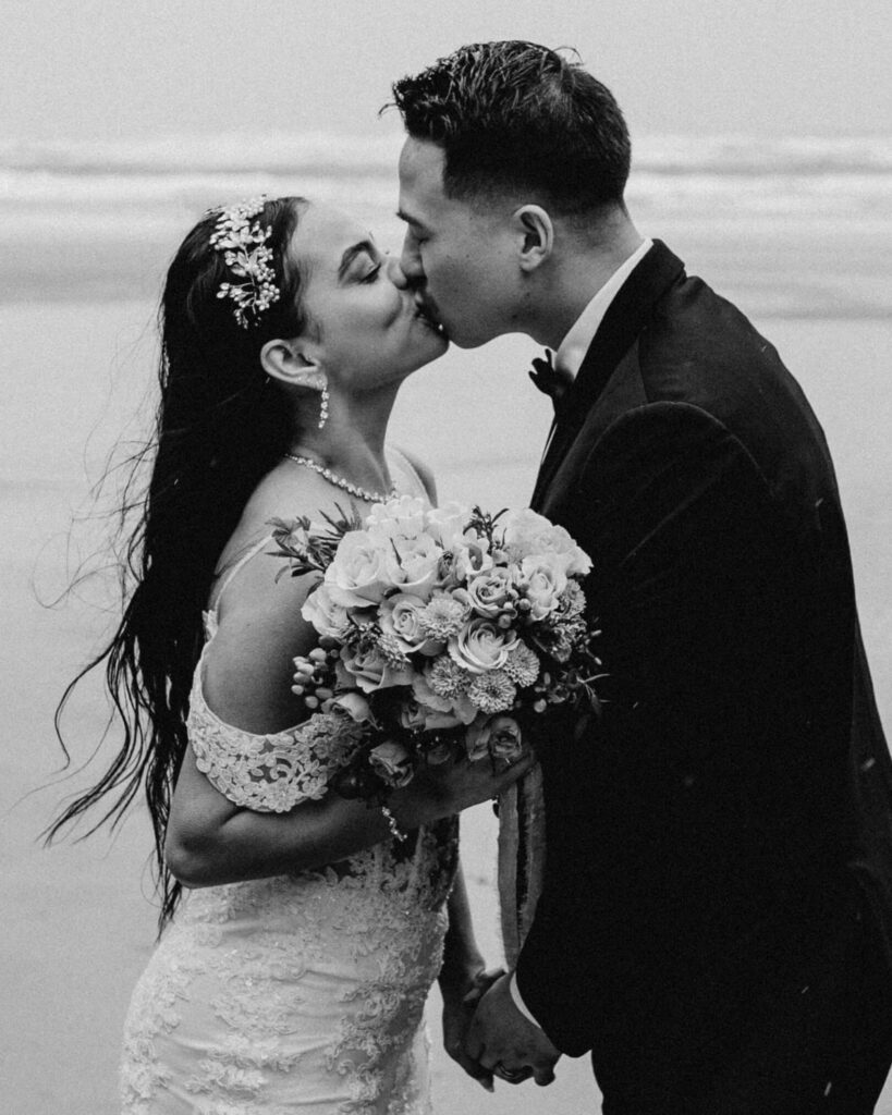 Couple exchanges vows on the beach at a hug point elopement