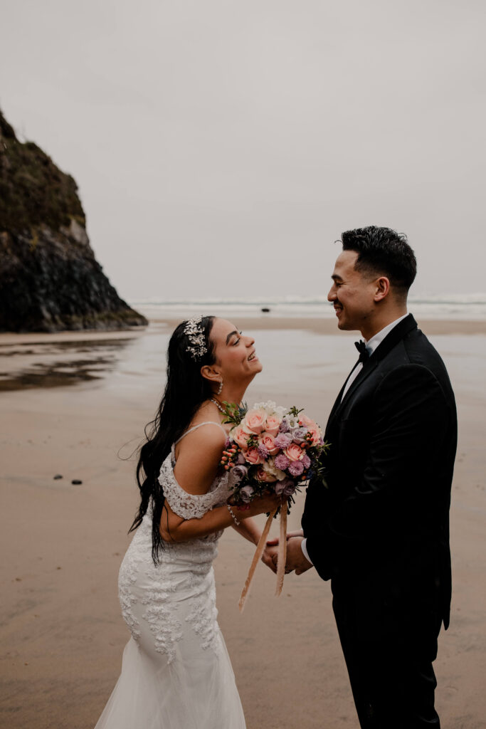 Couple exchanges vows on the beach at a hug point elopement