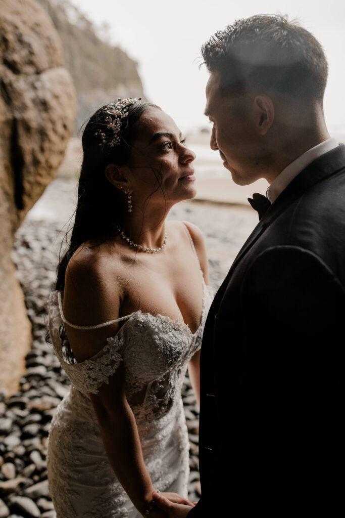 Couple embraces under a cave at their hug point oregon elopement