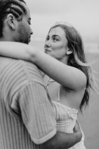 Couple on the beach at an Oregon coast engagement session shot by Ronny and Rene.