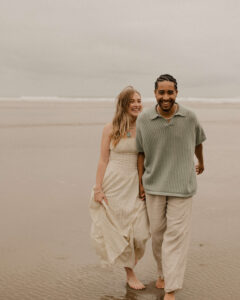 Couple runs on the beach at an Oregon coast engagement session shot by Ronny and Rene.