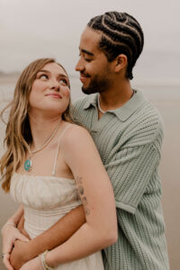 Couple on the beach at an Oregon coast engagement session shot by Ronny and Rene.