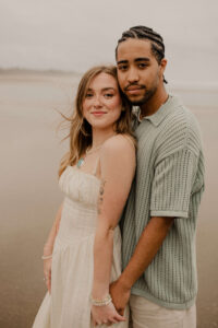 Couple on the beach at an Oregon coast engagement session shot by Ronny and Rene.