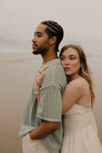 Couple on the beach at an Oregon coast engagement session shot by Ronny and Rene.