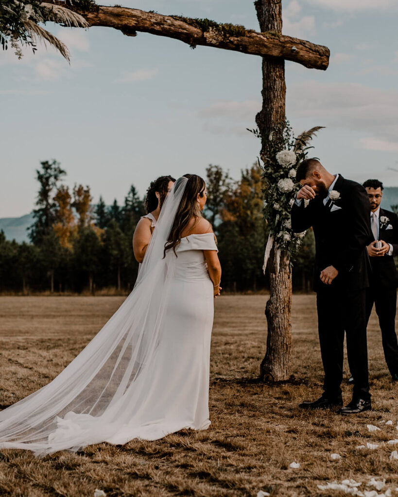 Groom cries at the sight of his bride as she walks down the aisle.