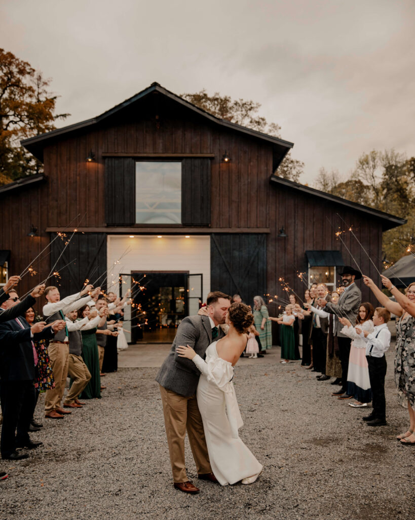 sage and social modern farmhouse wedding couple kissing