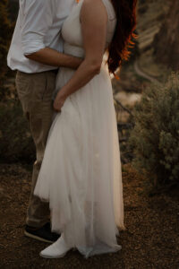 couple hugging and kissing at smith rock elopement photoshoot