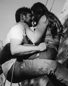 couple rock climbing with each other engagement photoshoot at smith rock