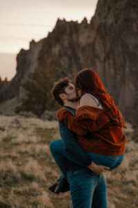 couple kisses at smith rock for an engagement session in Oregon