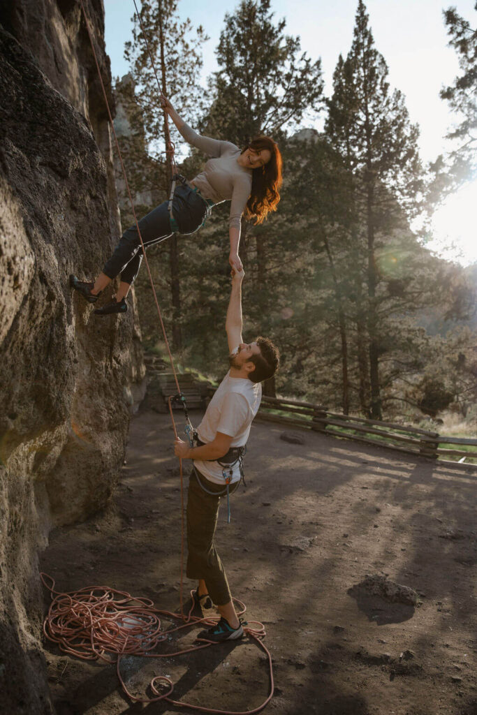 couple hiking together at smith rock holding hands for engagement photoshoot