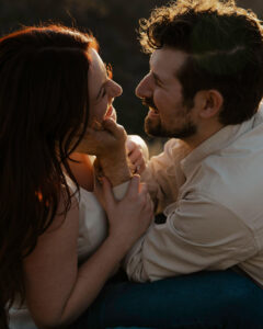 engaged couple laughing closely together lovingly