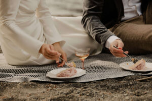 elopement cake in front of lake at olympic national park