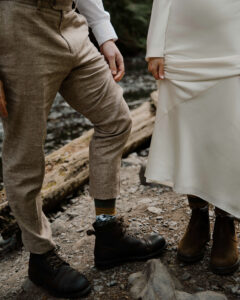 elopement couple wearing hiking boots at olympic national park river
