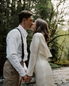 elopement couple kiss at olympic national park river
