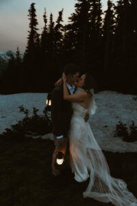 elopement couple at olympic national park mountain with snow and lanterns at night