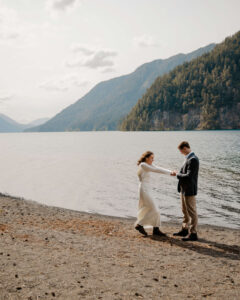 wedding couple dancing in front of lake at olympic national park