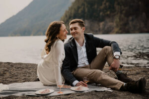 wedding couple picnic in front of lake at olympic national park