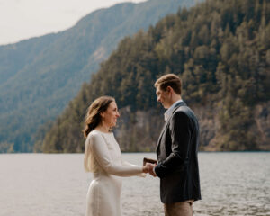 elopement couple at olympic national park lake reciting vows