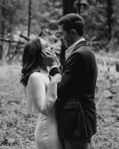 elopement couple at olympic national park forest, groom holds brides face in hands