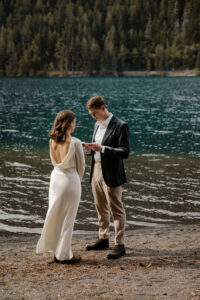elopement couple at olympic national park lake reciting vows