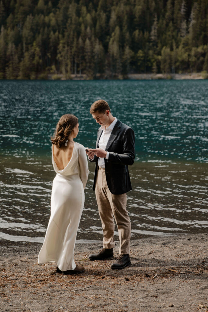 elopement couple at olympic national park lake reciting vows