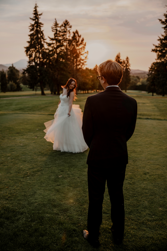 bride spinning dress on golf course with groom watching in golden hour at corvallis club in oregon