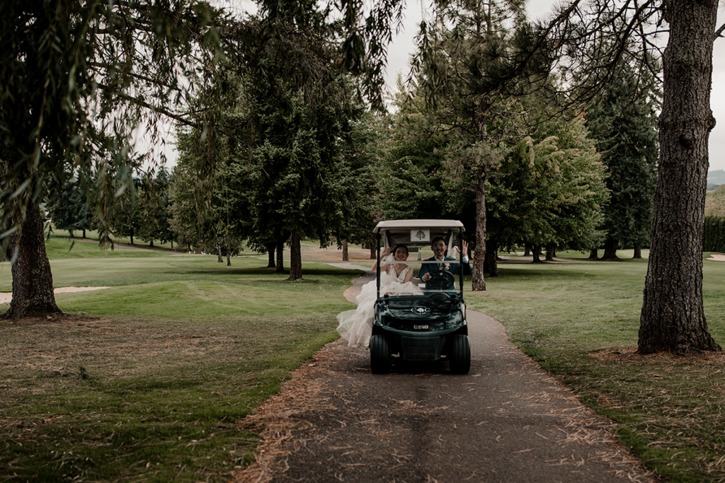 wedding couple driving in a golf cart at the corvallis club in oregon