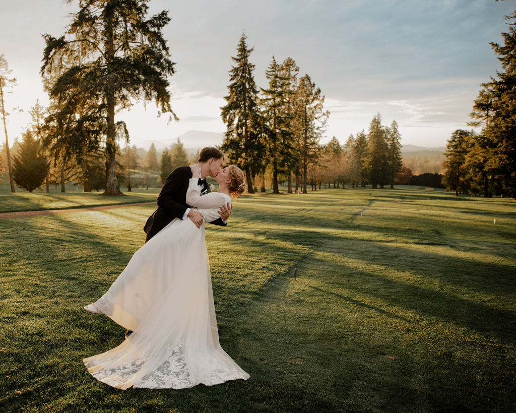 groom dips bride in romantic kiss on golf course at the corvallis club in oregon