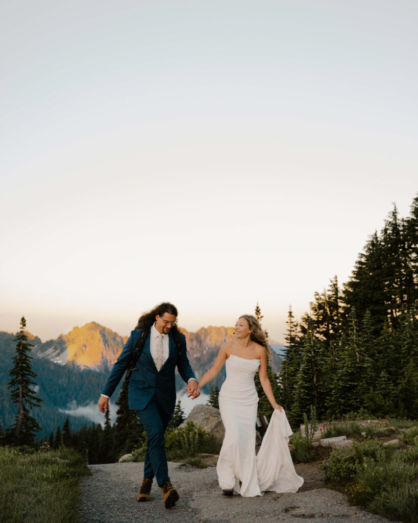 elopement couple hold hands on mount rainier hike after their elopement ceremony