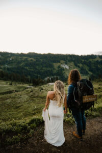 couple holds hands while hiking in mount rainier after their elopement