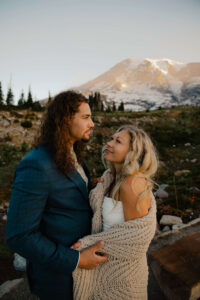 elopement couple with blanket during golden hour hiking in mount rainier