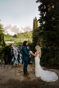 elopement by the waterfall at mount rainier reading each other vows