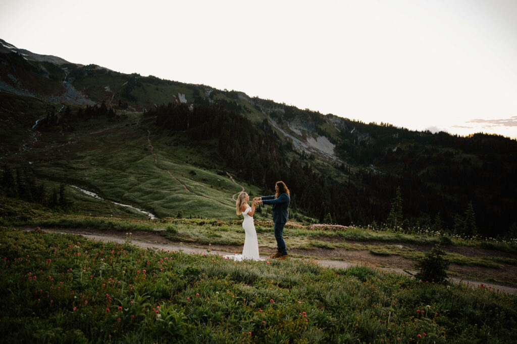 couple dances in heights of mount rainier hike after elopement