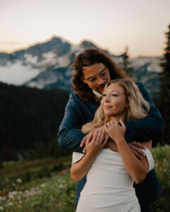 groom holds bride in arms on mount rainier hike after eloping