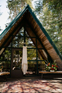 bride's dress hands in front of the mount rainier cabin for the elopement