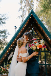 elopement couple kisses surrounded by bubbles at mount rainier cabin