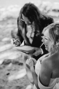 bride giggles and groom fills our marriage certificate at mount rainier elopement