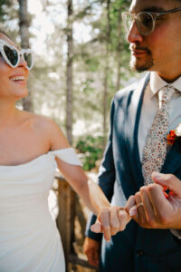 elopement couple pinky promising with rings on in glasses