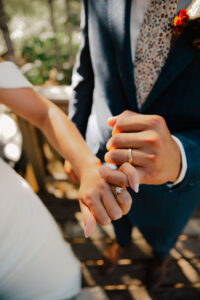 elopement couple pinky promising each other displaying their rings
