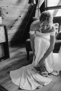 bride fastens shoes for her mount rainier elopement