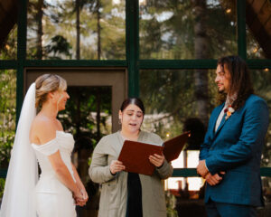 officiant reads to bride and groom at mount rainier elopement ceremony