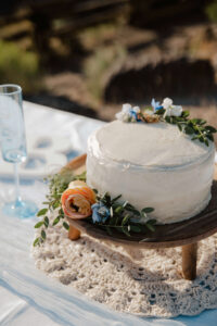 Closeup of wedding cake with floral accents.