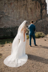 Bride and groom do their first look during golden hour at Smith Rock.
